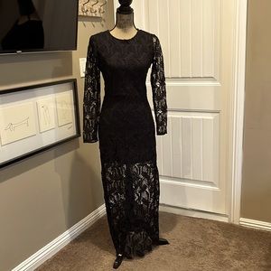 Long dress with sheer sleeves/bottom. There is no stretch in this dress.